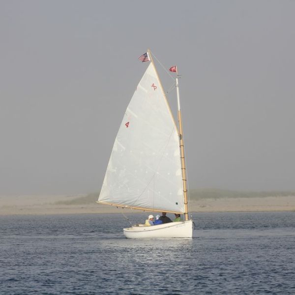a man flying a kite in a boat on a body of water